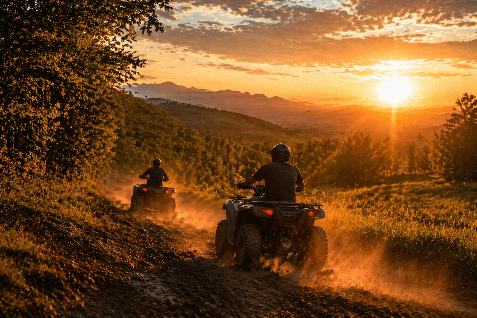 ATVs riding mountain trails at sunset
